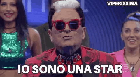 a man wearing sunglasses and a red jacket says i 'm a star .
