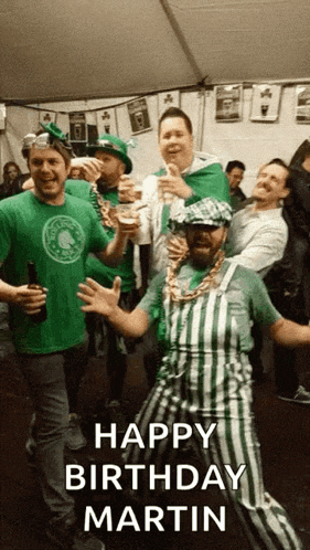 a group of men are celebrating st. patrick 's day and one of them is wearing green overalls