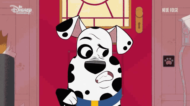 a dalmatian dog standing in front of a red door with disney written on the bottom right