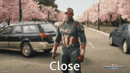 a man in a captain america costume is walking down a street with a car in the background and the word close is visible