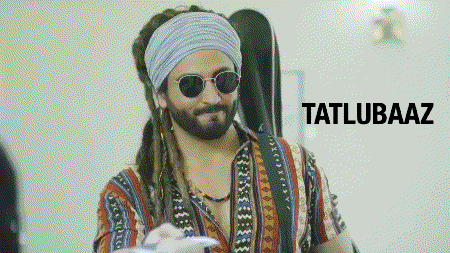 a man with dreadlocks wearing sunglasses and a headband with the word tatlubaaz written below him