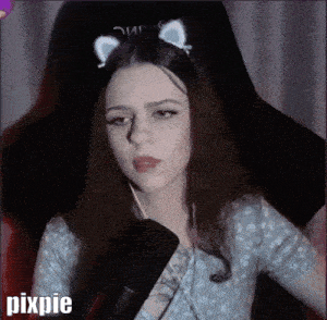 a woman wearing a cat ear headband is sitting in a chair with pixpie written in the corner