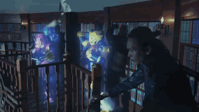 a man stands on a balcony looking at a display of ghosts in a library