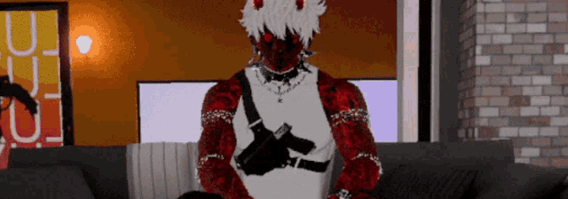 a man with horns is sitting on a couch with a gun in his hand