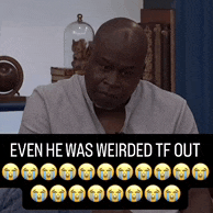 a man sitting in front of a sign that says ' even he was weirded tf out '