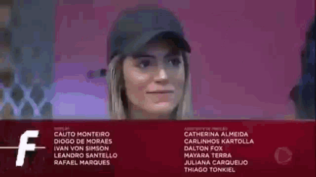 a woman wearing a baseball cap is smiling in front of a purple background with the name catherine almeida at the bottom