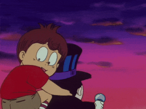 a boy in a red shirt is hugging a man in a black hat
