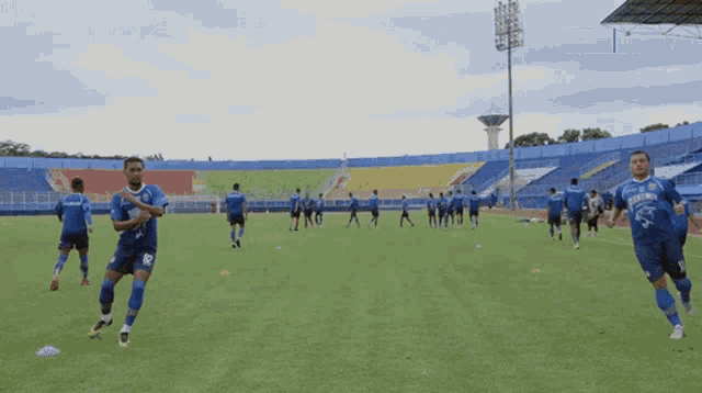 a group of soccer players on a field with one wearing a jersey that says ' persija ' on it
