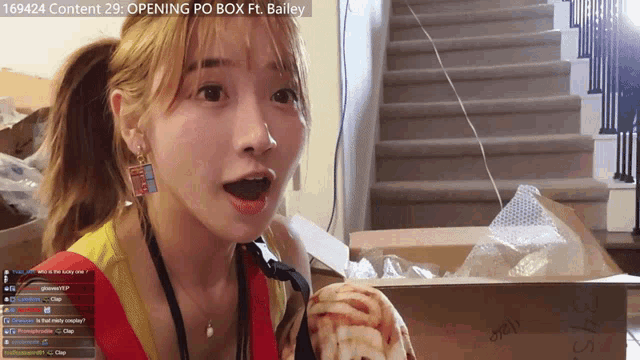 a girl with a surprised look on her face in front of a box that says bailey on the top