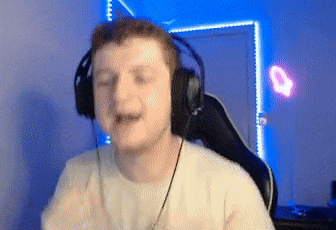 a man wearing headphones is sitting in a chair in front of a blue wall .