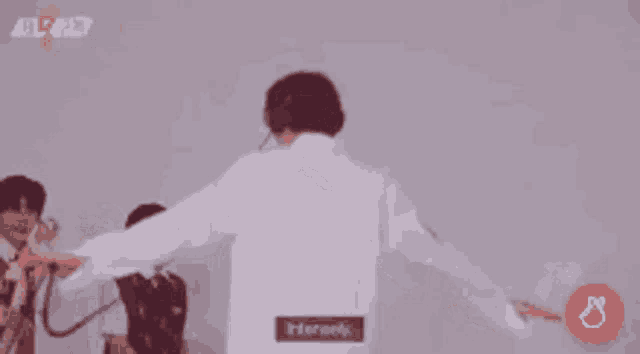 a man wearing a white shirt with the word his on it