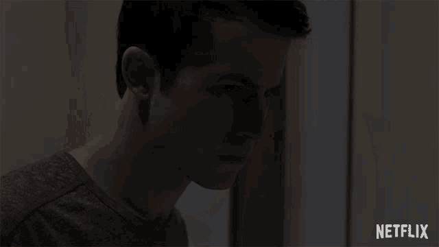 a close up of a man 's face with a netflix logo in the background