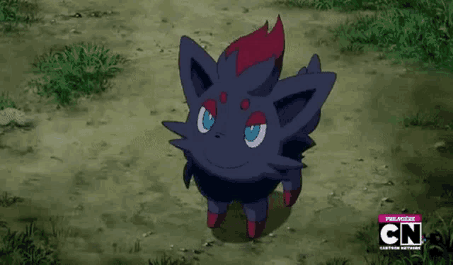 a black and red pokemon is standing on a dirt road .