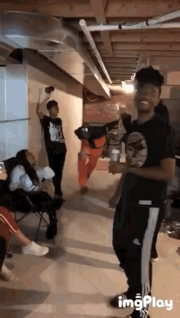 a group of people are dancing in a basement with the words imgplay at the bottom of the screen