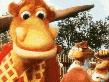 a group of cartoon characters are standing next to each other and looking at the camera .