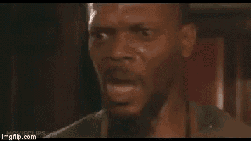 a man with a beard is making a funny face with his mouth open .