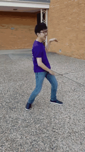 a young man wearing a purple shirt that says tmsf