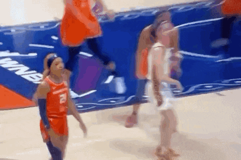 a basketball player wearing a number 8 jersey is walking on the court .