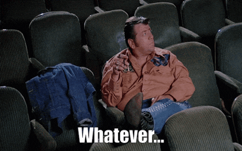 a man is sitting in a theater smoking a cigarette and the words whatever are above him