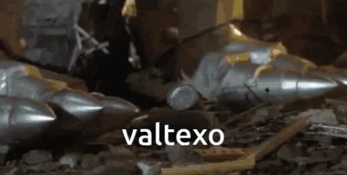 a bunch of missiles are laying on the ground and the word valtexo is on the bottom left