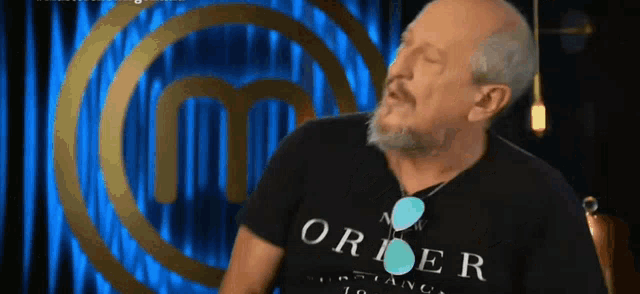 a man wearing a black shirt that says order