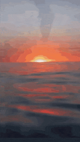 a sunset over a body of water with the sun shining through the clouds