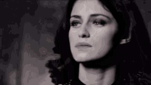 a close up of a woman 's face with a serious look on her face .