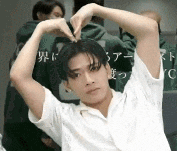a man is making a heart shape with his hands .