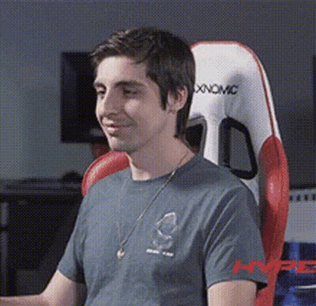 a man is sitting in a chair with the word hype on it