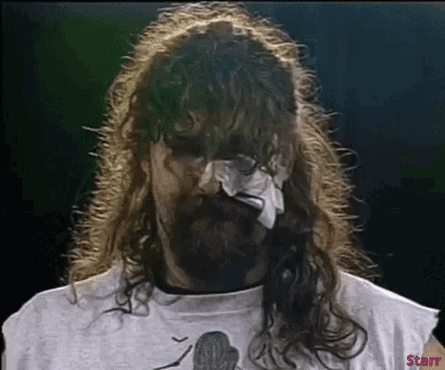a man with long hair and a beard is wearing a white shirt that says starr on the bottom
