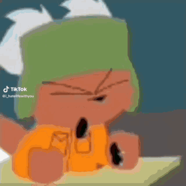 a cartoon character with a green hat is sitting at a table with his fist in the air .