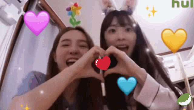 two girls are making a heart shape with their hands and hearts are surrounding them
