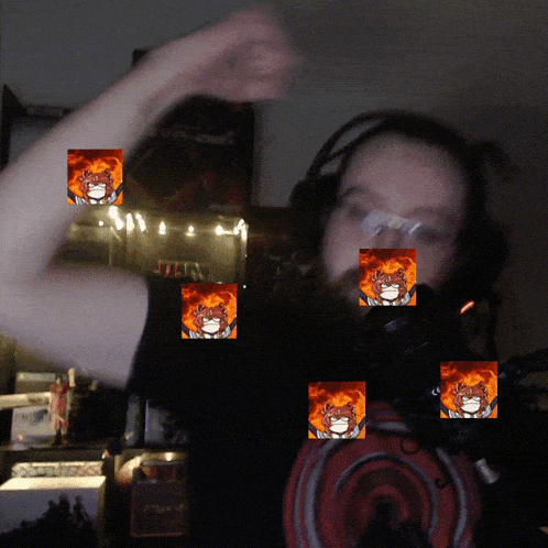a man wearing headphones and a shirt that says ' titan ' on it stands in front of a microphone