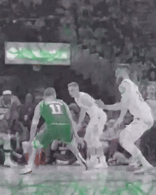 a group of basketball players are playing a game of basketball .