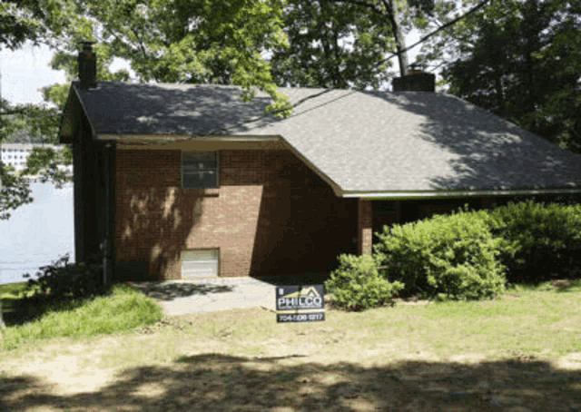 a brick house with a philco sign in front