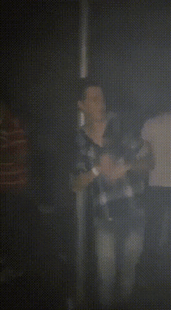 a blurry picture of a man in a dark room