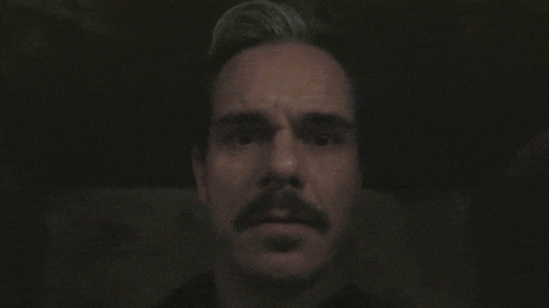 a close up of a man 's face with the words meddi written on it