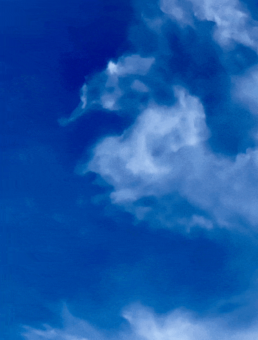 a blue sky with white clouds that look like a dragon