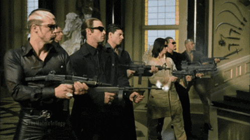 a group of people holding guns in front of a wall with the number 1747 on it