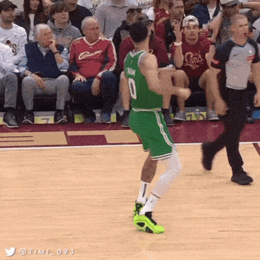 a basketball player in a green jersey with the number 0 on it