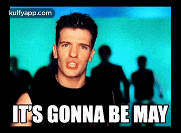 a man in a black shirt says it 's gonna be may in front of a crowd of people