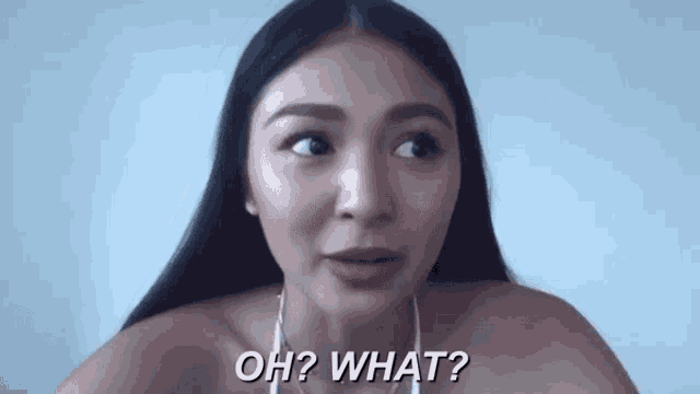 a woman is looking at the camera and saying oh what .
