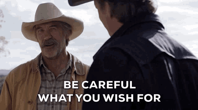 a man in a cowboy hat is talking to another man with the words " be careful what you wish for " below him