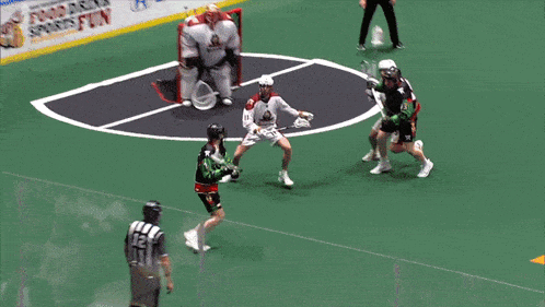 a lacrosse game is being played in front of an advertisement that says drink is fun