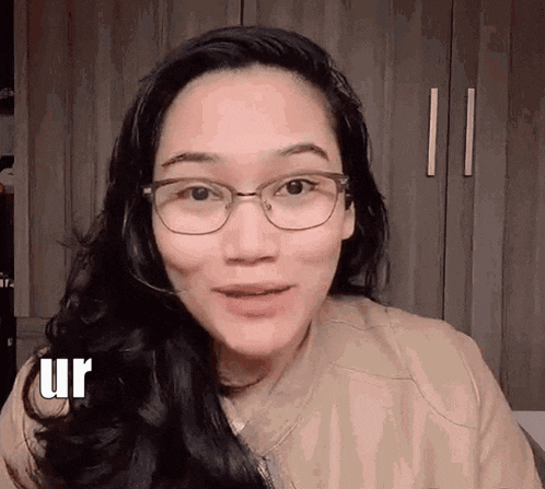 a woman wearing glasses and a headset is making a face .