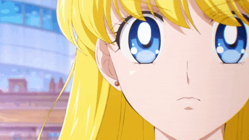 a close up of a girl 's face with big blue eyes