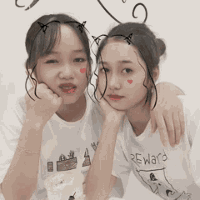 two girls are posing for a picture with one wearing a reward shirt