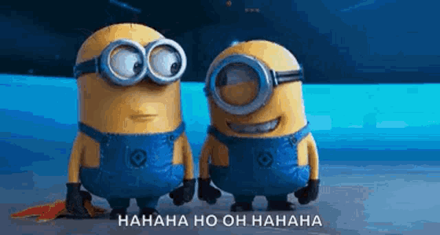 two minions are standing next to each other and laughing . one of the minions is wearing goggles .