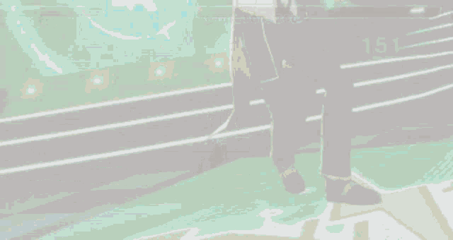 a pixel art of a man standing on a stage with a green background .