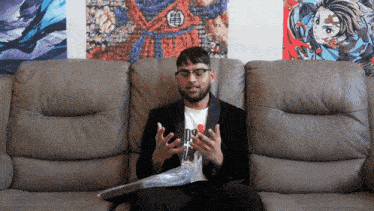 a man sitting on a couch wearing a t-shirt that says ' no '